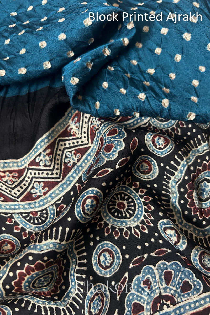Close up of natural dye black Ajrakh print on handcrafted stole with intricate block printed motifs and delicate bandhani patterns.
