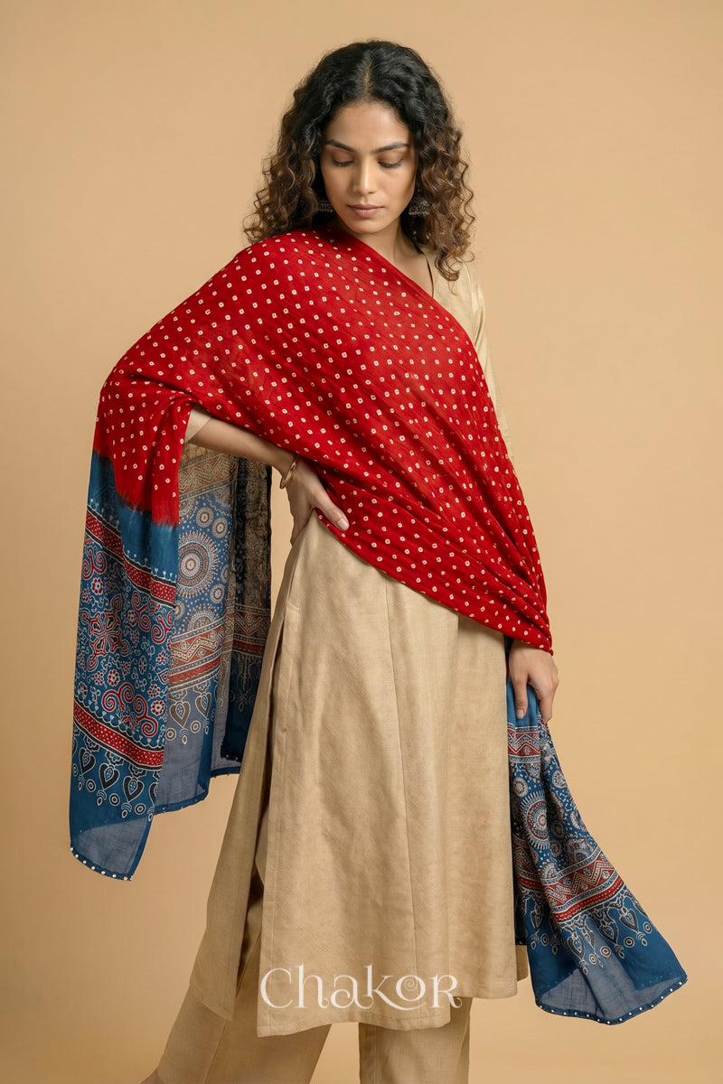  Red Bandhani modal stole styled across shoulders with detailed Indigo Ajrakh pallu and traditional hand tied pattern.
