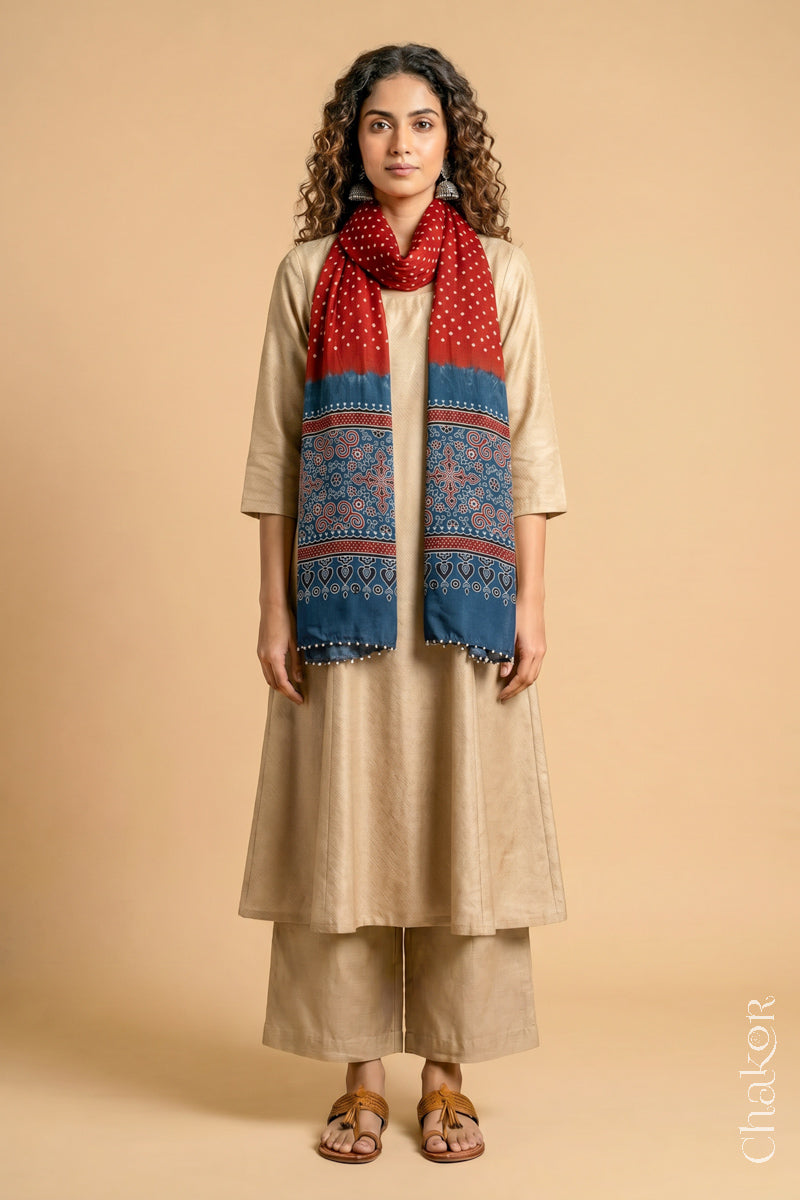 Full length view of handcrafted  Red Bandhani stole with Indigo Ajrakh pallu worn as dupatta wrapped around the neck.
