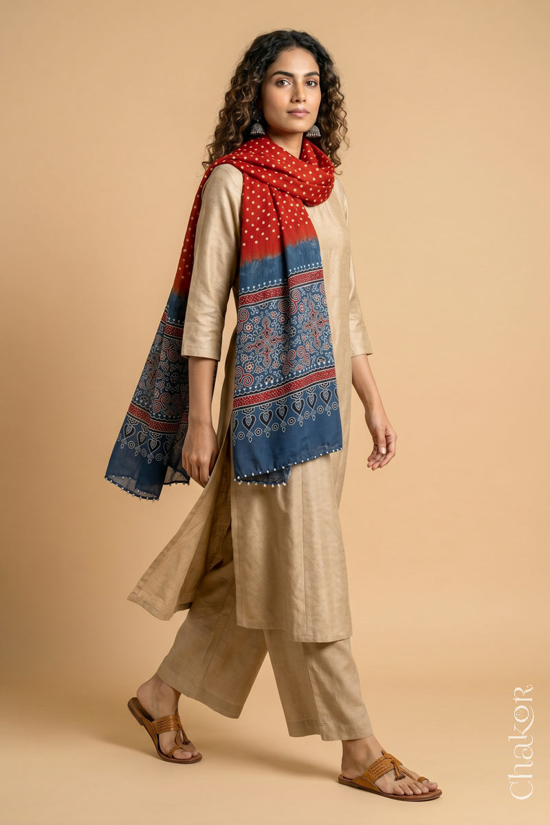 Full length view of handcrafted  Red Bandhani stole with Indigo Ajrakh pallu worn as dupatta wrapped around the neck.
