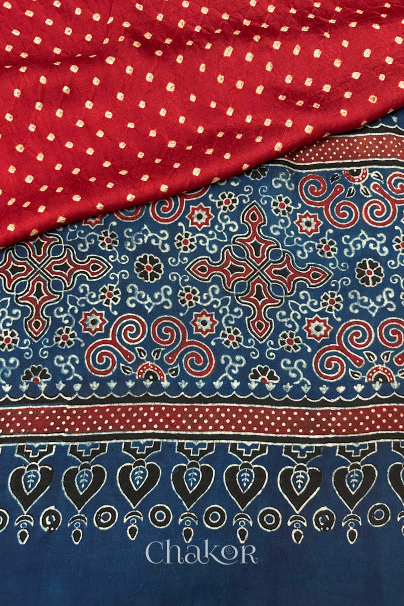 Hand tied  Red Bandhani patterns on modal stole with contrast   Red Ajrakh pallu detail.
