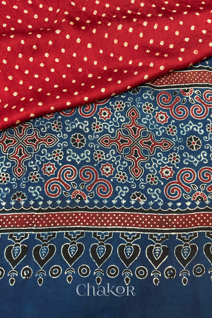 Hand tied  Red Bandhani patterns on modal stole with contrast   Red Ajrakh pallu detail.
