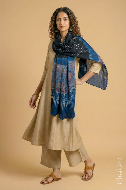 Black Bandhani modal stole styled across shoulders with detailed Indigo Ajrakh pallu and traditional hand tied pattern.
