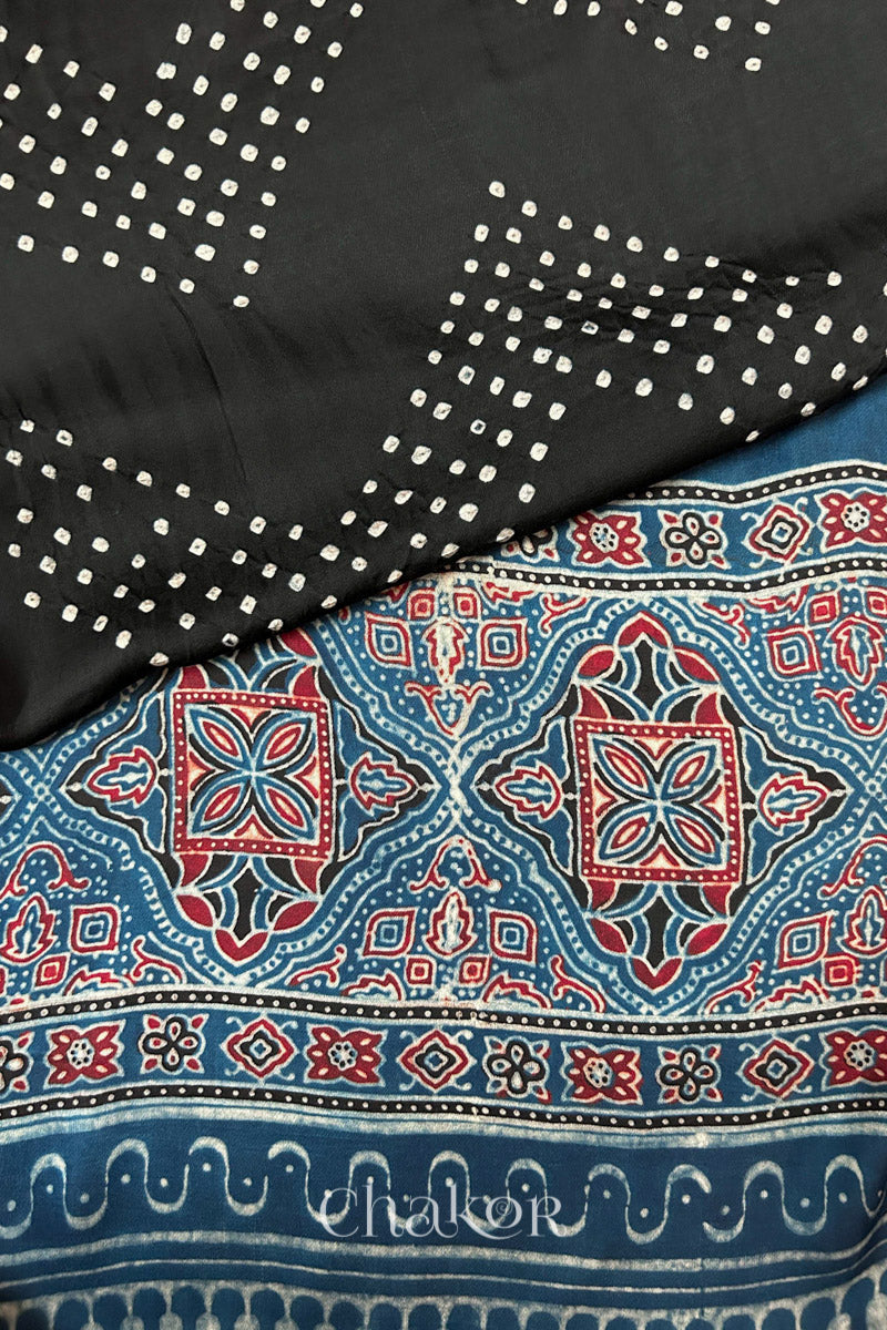 Hand tied  Black Bandhani patterns on modal stole with contrast  Indigo Ajrakh pallu detail.
