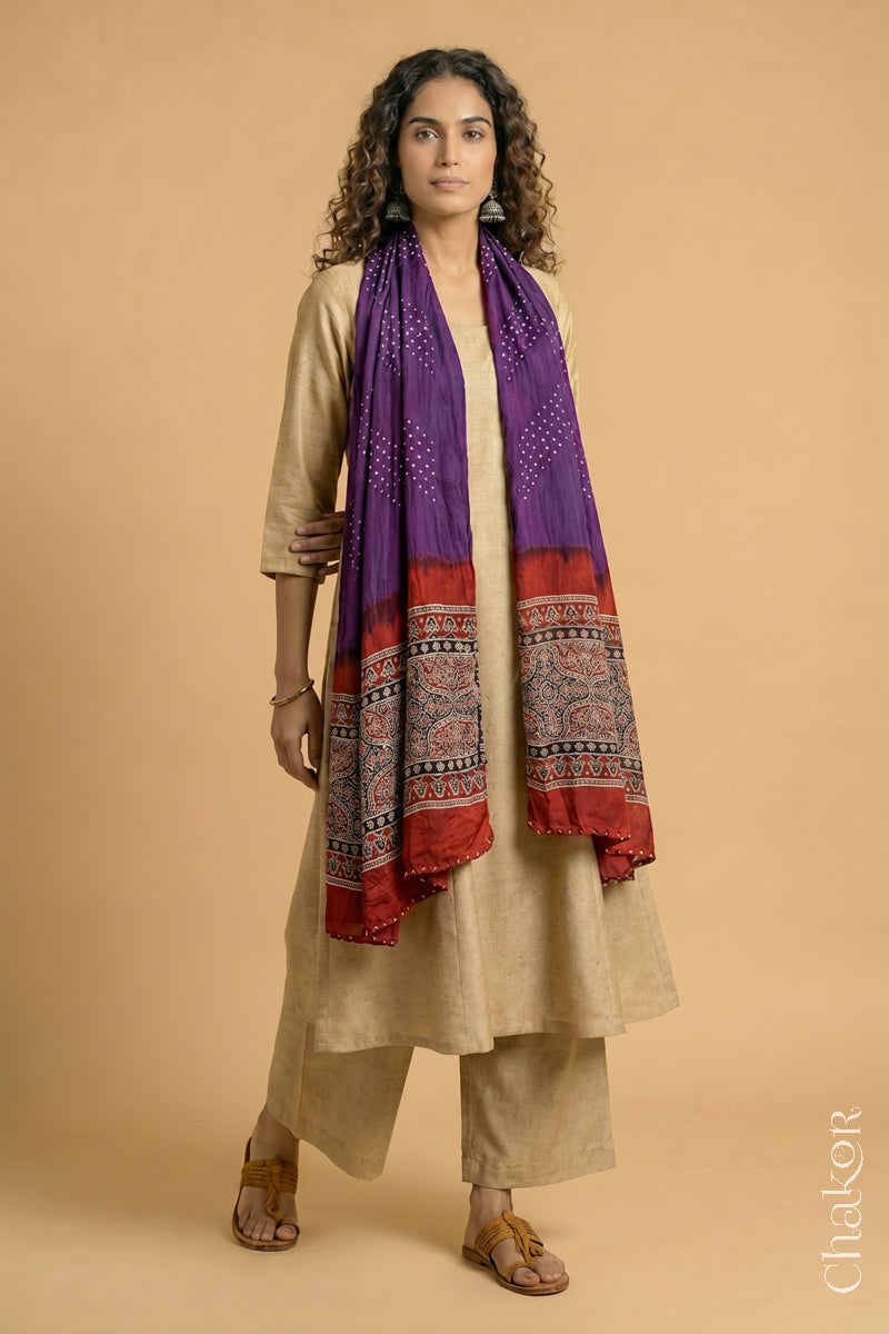 Handcrafted Bandhani Ajrakh modal stole draped on model with Purple Bandhani body and Madder Red Ajrakh pallu.
