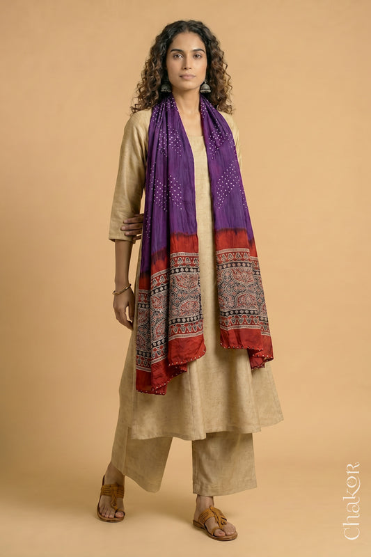 Handcrafted Bandhani Ajrakh modal stole draped on model with Purple Bandhani body and Madder Red Ajrakh pallu.
