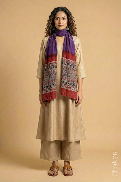Full length view of handcrafted Purple Bandhani stole with iron  Madder Red Ajrakh pallu worn as dupatta wrapped around the neck.
