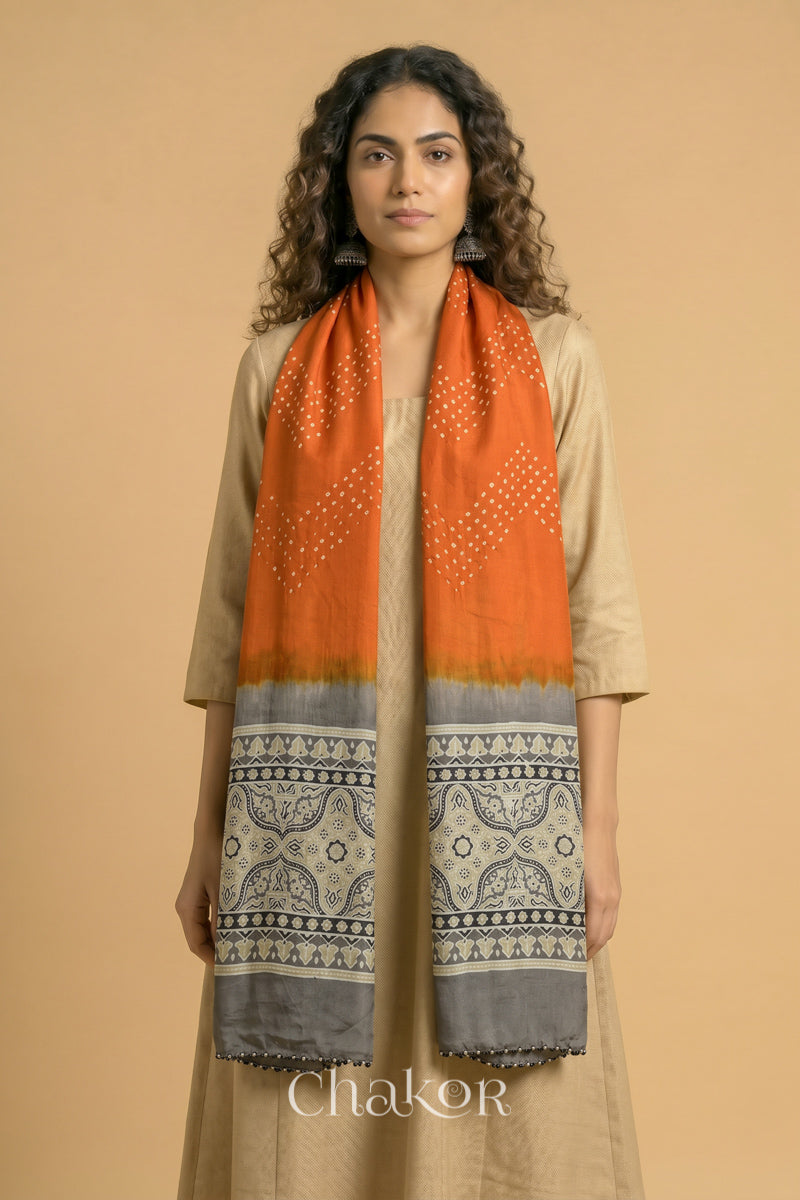 Full length view of handcrafted  Orange Bandhani stole with Taupe Beige Ajrakh pallu worn as dupatta wrapped around the neck.
