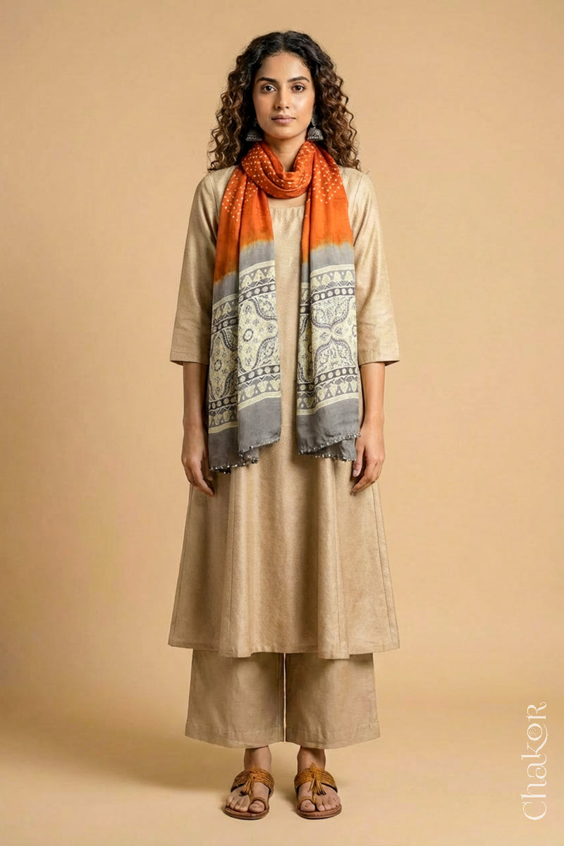 Full length view of handcrafted  Orange Bandhani stole with Taupe Beige Ajrakh pallu worn as dupatta wrapped around the neck.
