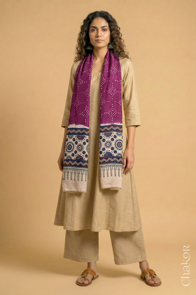 Handcrafted Bandhani Ajrakh modal stole draped on model with Magenta Bandhani body and Off-white Ajrakh pallu.
