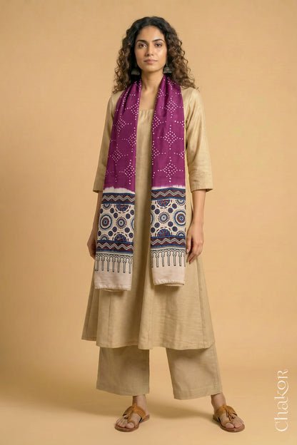 Handcrafted Bandhani Ajrakh modal stole draped on model with Magenta Bandhani body and Off-white Ajrakh pallu.
