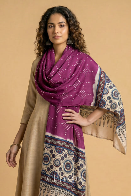  Magenta Bandhani modal stole styled across shoulders with detailed Off-white Ajrakh pallu and traditional hand tied pattern.
