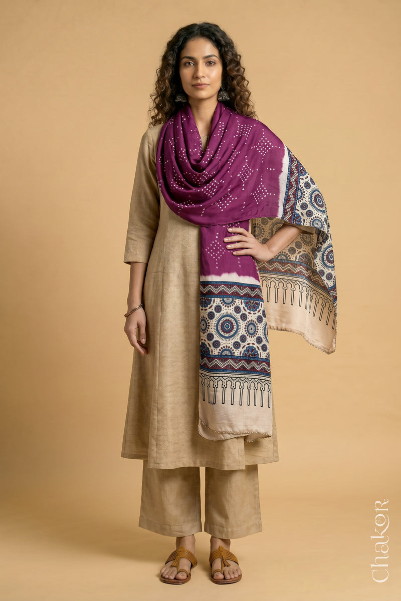 Full length view of handcrafted  Magenta Bandhani stole with Off-white Ajrakh pallu worn as dupatta wrapped around the neck.
