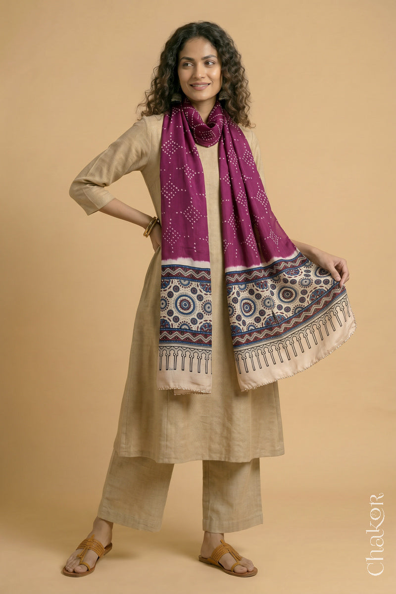 Full length view of handcrafted  Magenta Bandhani stole with Off-white Ajrakh pallu worn as dupatta wrapped around the neck.
