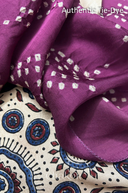 Magenta Hand tied Bandhani dots on modal stole with contrast ajrakh pallu detail showcasing fabric texture and softness.
