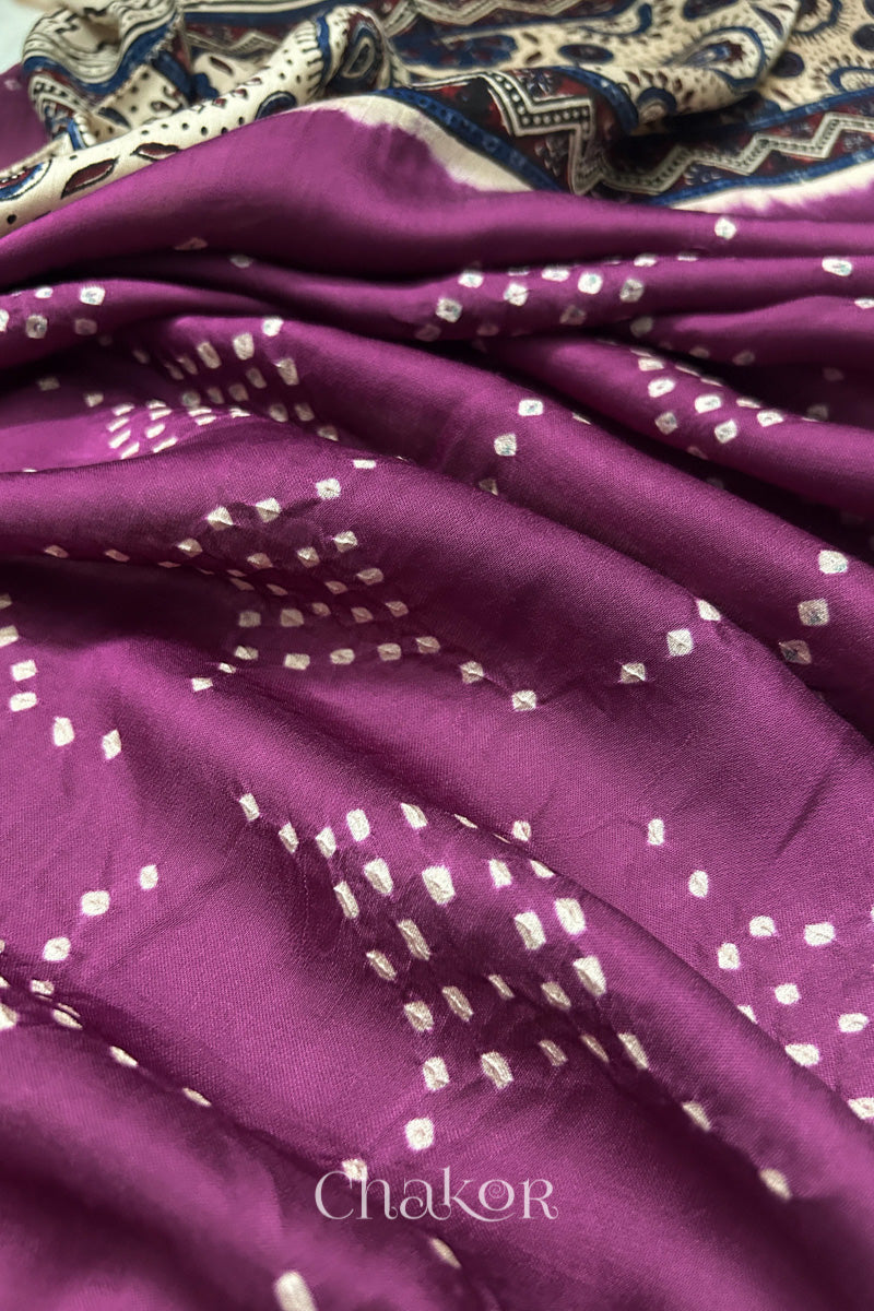 Magenta Hand tied Bandhani dots on modal stole with contrast ajrakh pallu detail showcasing fabric texture and softness.

