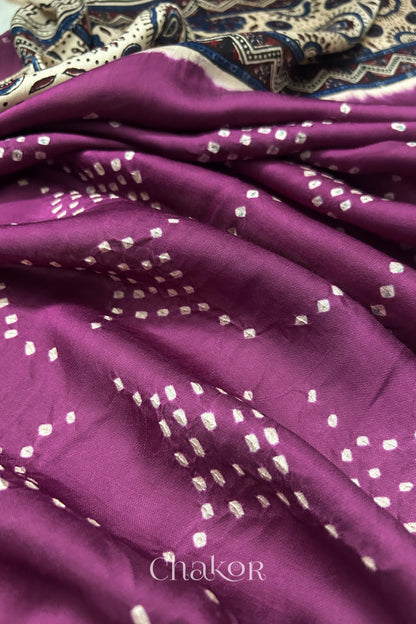 Magenta Hand tied Bandhani dots on modal stole with contrast ajrakh pallu detail showcasing fabric texture and softness.
