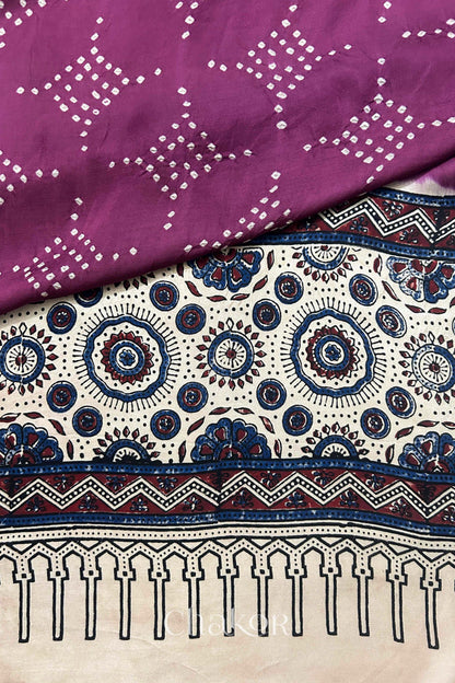 Hand tied  Magenta Bandhani patterns on modal stole with contrast  Off-white Ajrakh pallu detail.
