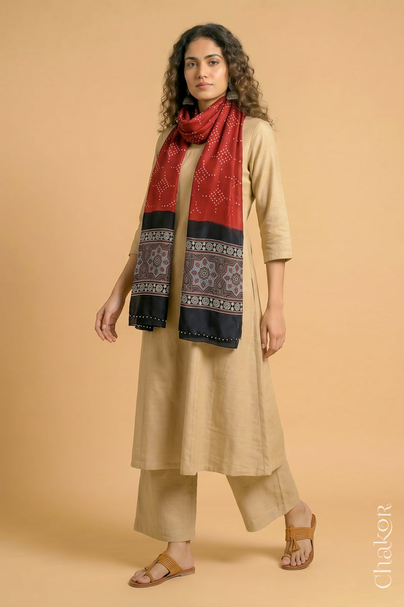 Full length view of handcrafted Red Bandhani stole with iron  black ajrakh pallu worn as dupatta wrapped around the neck.

