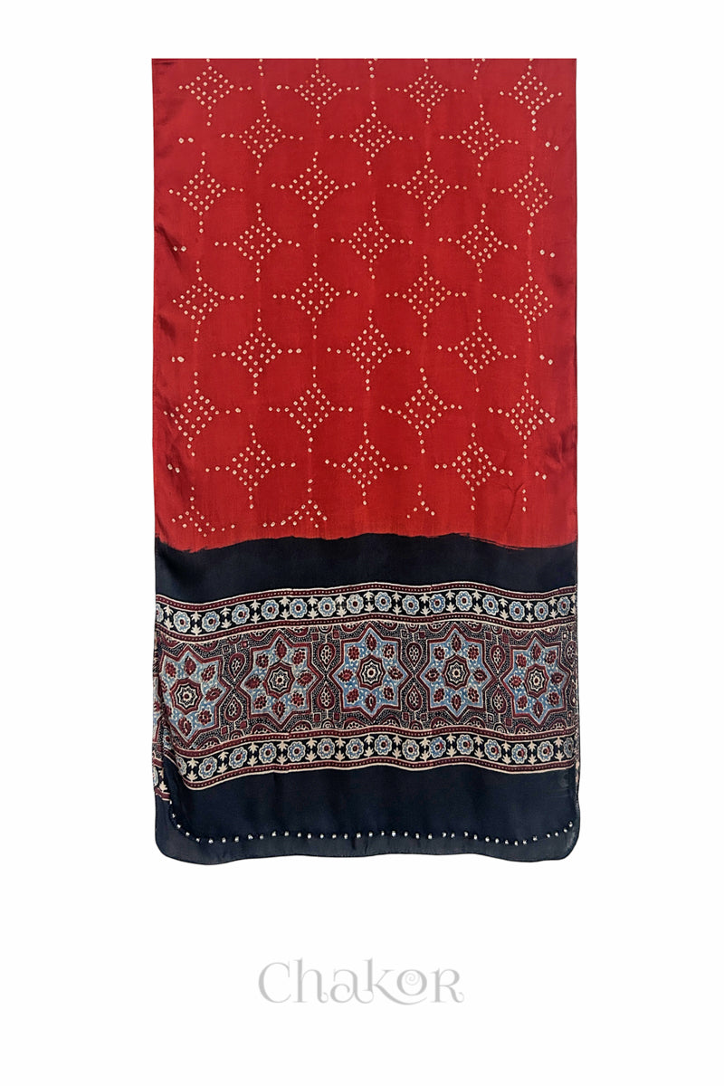 Red Bandhani modal stole with black Ajrakh pallu and traditional block print layout and glass bead edging.
