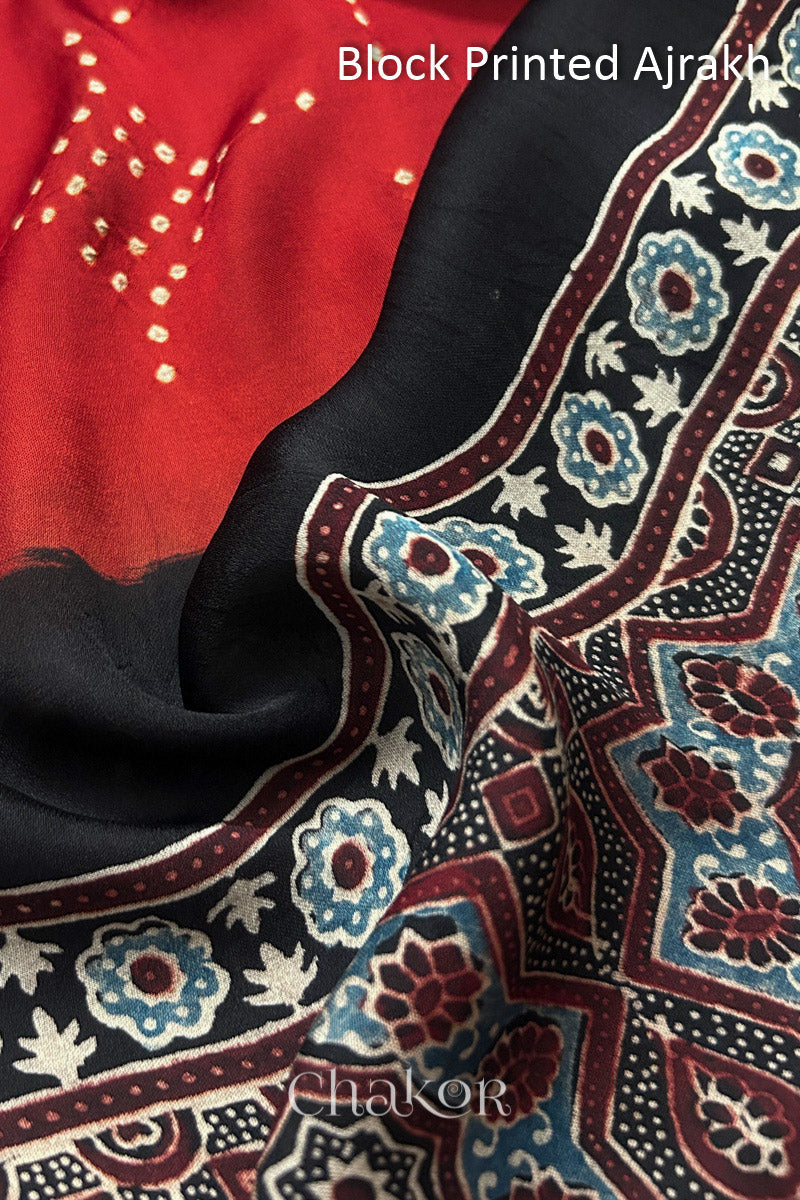 Close up of natural dye black Ajrakh print on handcrafted stole with intricate block printed motifs and delicate bandhani patterns.
