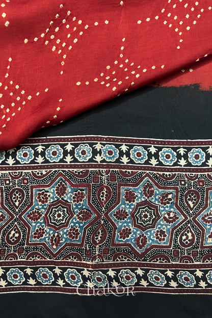 Detailed Ajrakh pattern on modal stole showing traditional hand block printing and intricate bandhani motifs.
