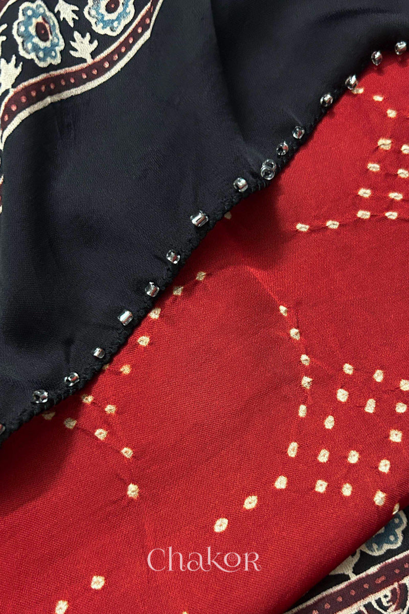 Red Bandhani and black Ajrakh combination modal stole with glass bead edging detail on pallu end.
