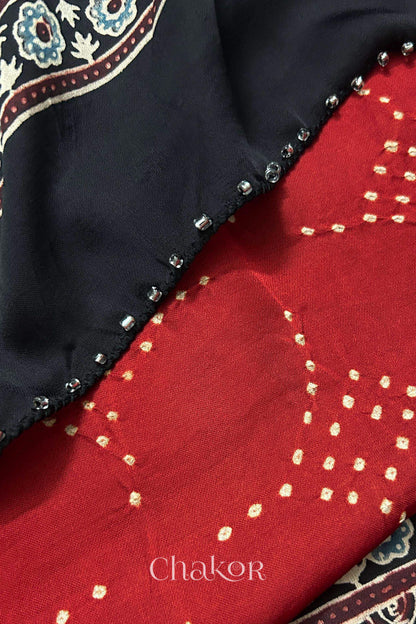 Red Bandhani and black Ajrakh combination modal stole with glass bead edging detail on pallu end.
