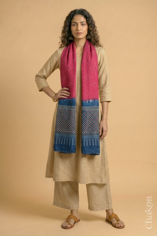 Handcrafted Bandhani Ajrakh modal stole draped on model with Strawberry Pink Bandhani body and Indigo Ajrakh pallu.
