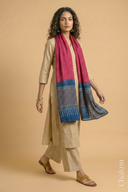 Full length view of handcrafted  Strawberry Pink Bandhani stole with Indigo Ajrakh pallu worn as dupatta wrapped around the neck.
