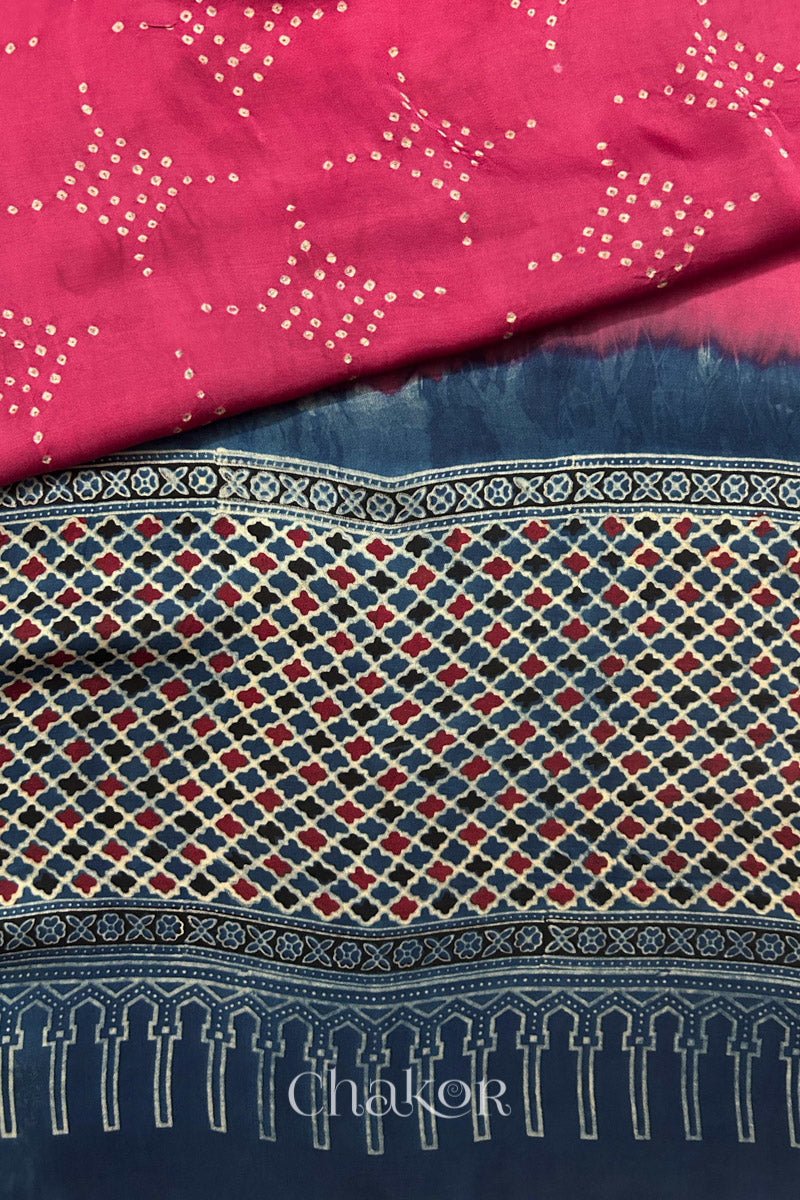 Hand tied  Strawberry Pink Bandhani patterns on modal stole with contrast   Indigo Ajrakh pallu detail.
