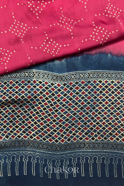 Hand tied  Strawberry Pink Bandhani patterns on modal stole with contrast   Indigo Ajrakh pallu detail.
