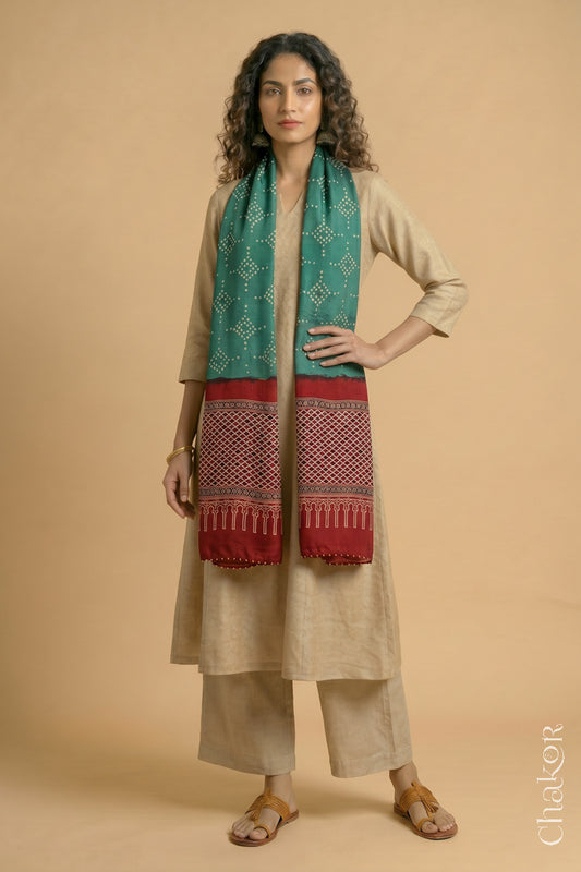 Handcrafted Bandhani Ajrakh modal stole draped on model with Turle Green Bandhani body and Madder Red Ajrakh pallu.
