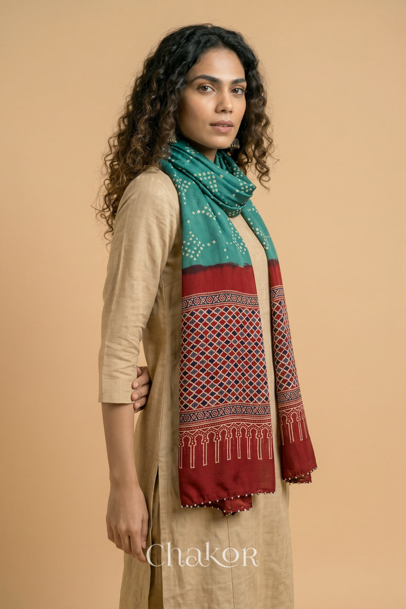 Full length view of handcrafted Turtle Green Bandhani stole with iron  Madder Red Ajrakh pallu worn as dupatta wrapped around the neck.

