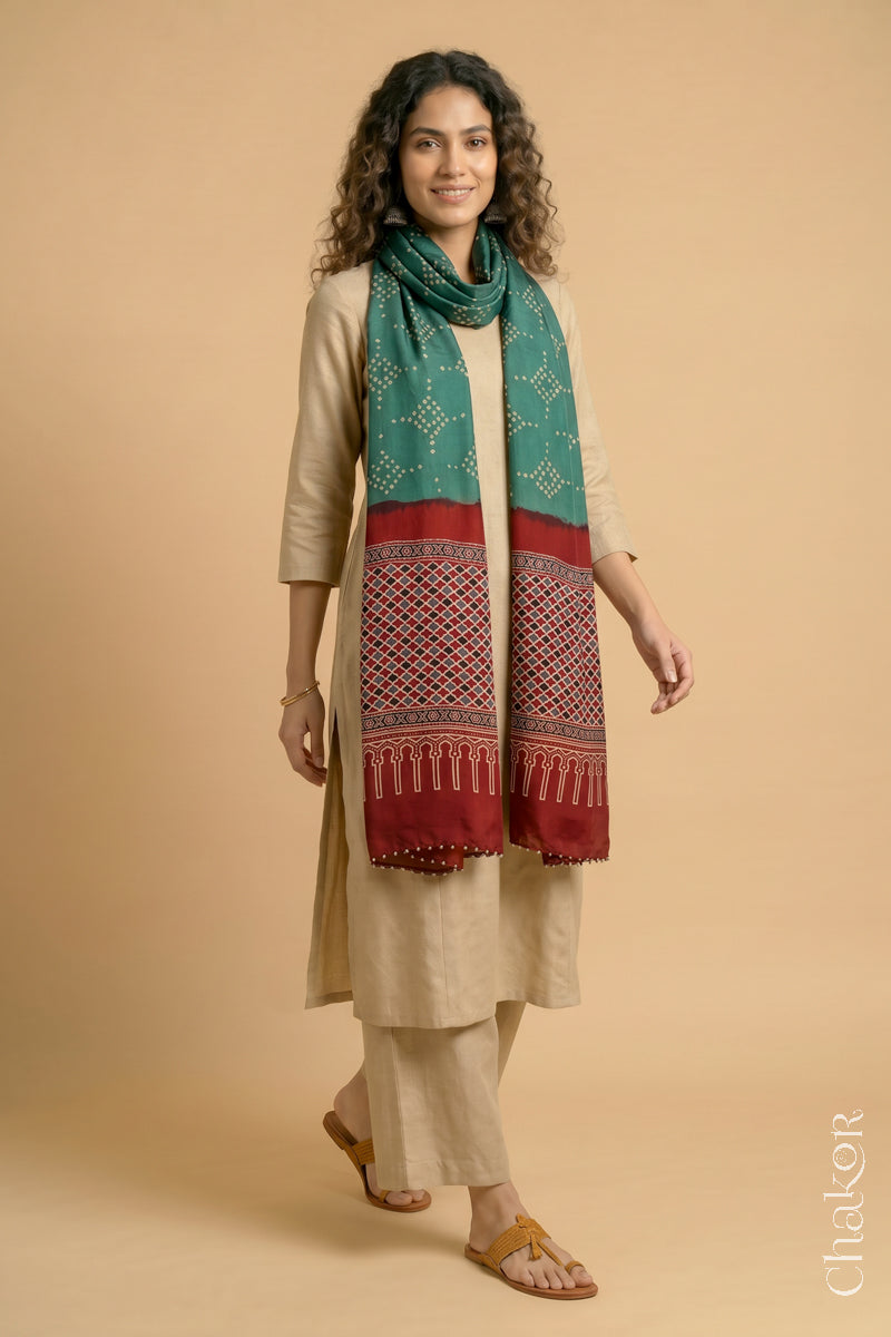 Full length view of handcrafted Turtle Green Bandhani stole with iron  Madder Red Ajrakh pallu worn as dupatta wrapped around the neck.
