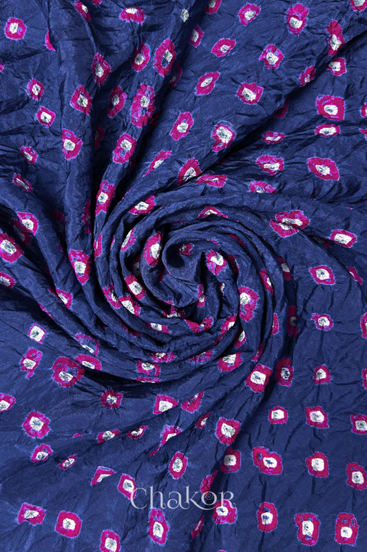 Blue Grey Mulberry silk fabric with dual colour Pink bandhani dots, arranged in a swirling design  & Chakor brand watermark.
