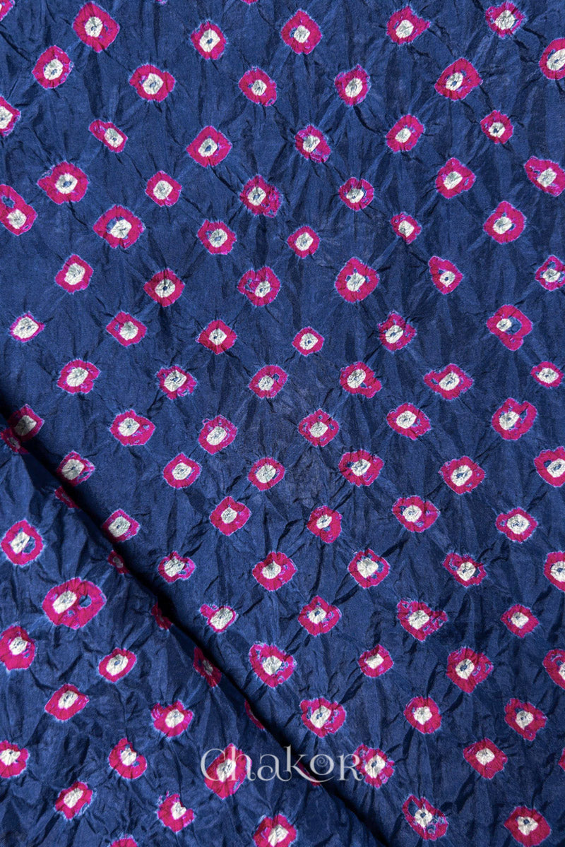 Blue Grey Mulberry silk fabric showcasing dual colour Pink bandhani patterns with folded corner and Chakor brand watermark.
