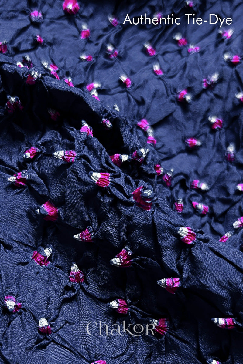 Close-up of Blue Grey mulberry silk fabric with Pink and white patterns, featuring texture of authentic bandhani patterns.
