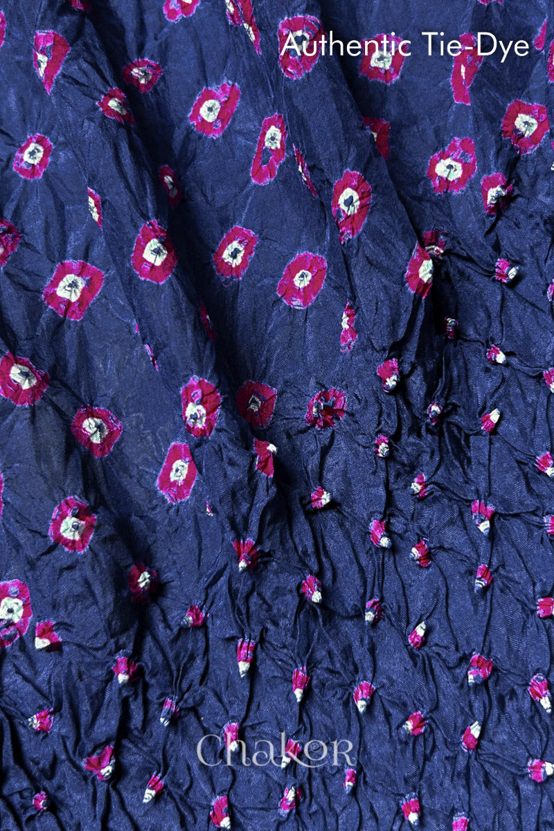 Close-up of Blue Grey mulberry silk fabric with Pink and white patterns, featuring texture of authentic bandhani patterns.
