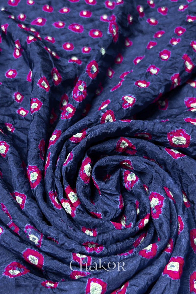 Blue Grey Mulberry silk fabric with dual colour Pink bandhani dots, arranged in a swirling design  & Chakor brand watermark.
