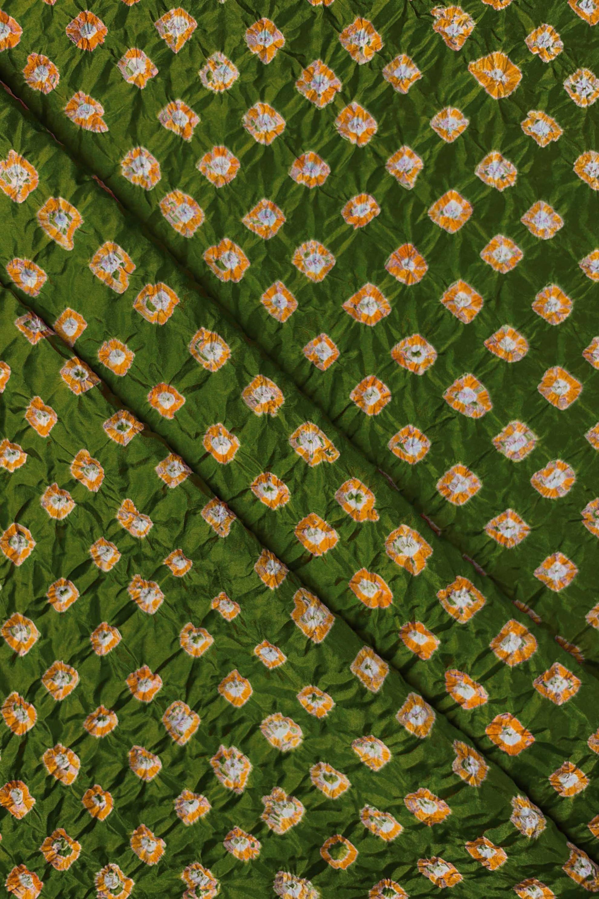 Mehendi Green Mulberry silk fabric showcasing dual colour Yellow bandhani patterns with folds and Chakor brand watermark.
