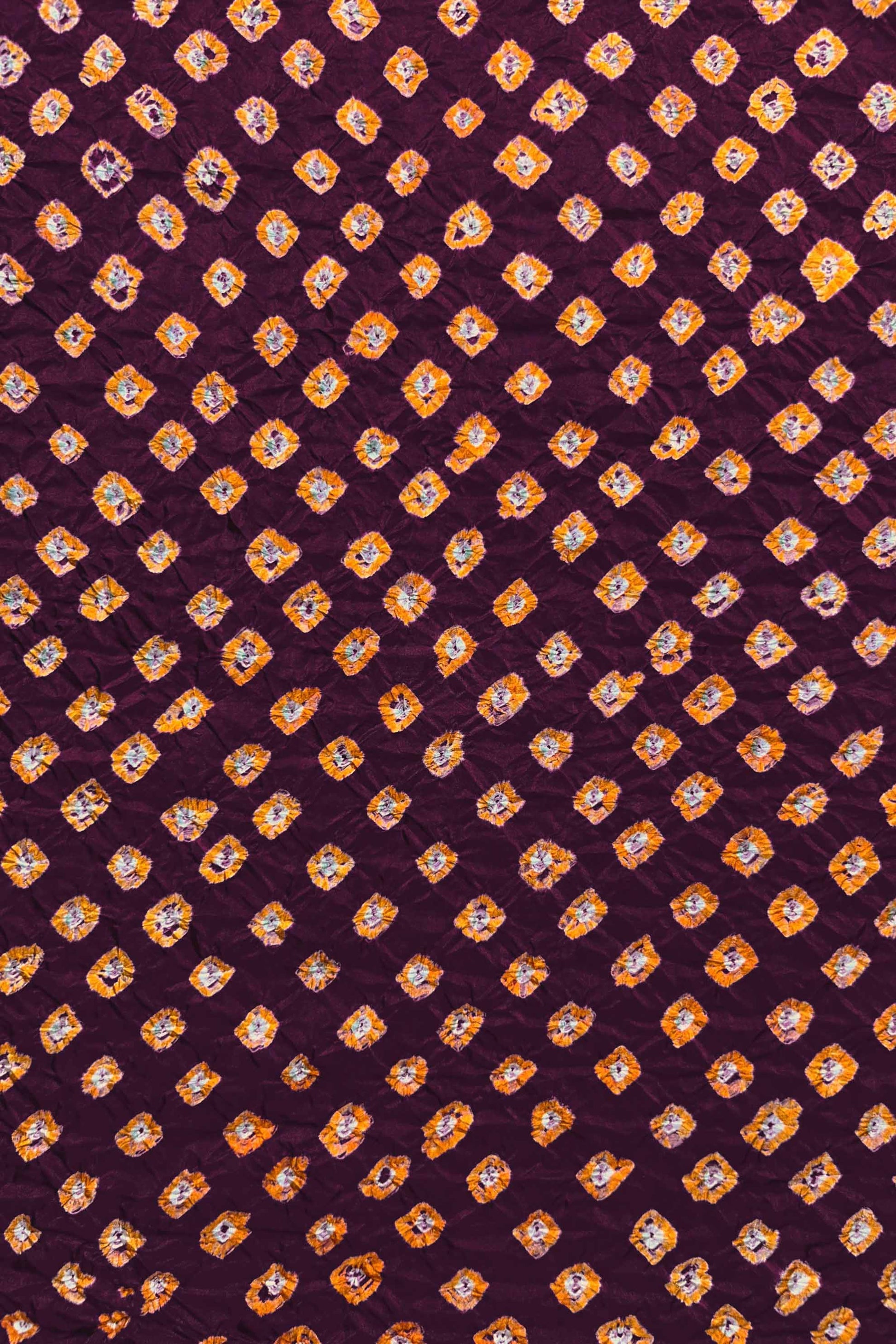 Maroon Mulberry silk fabric showcasing dual colour Yellow bandhani patterns and Chakor brand watermark.
