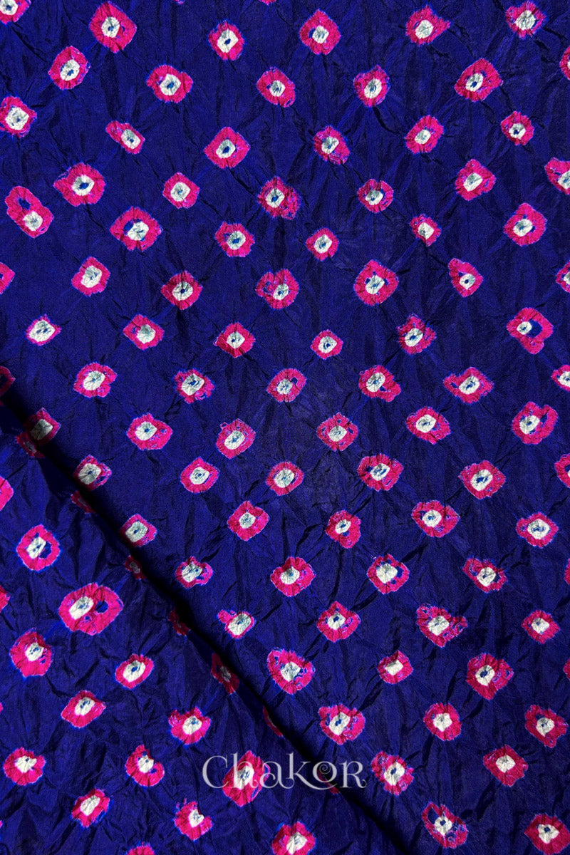 Navy Mulberry silk fabric showcasing dual colour Pink bandhani patterns with folded corner and Chakor brand watermark.

