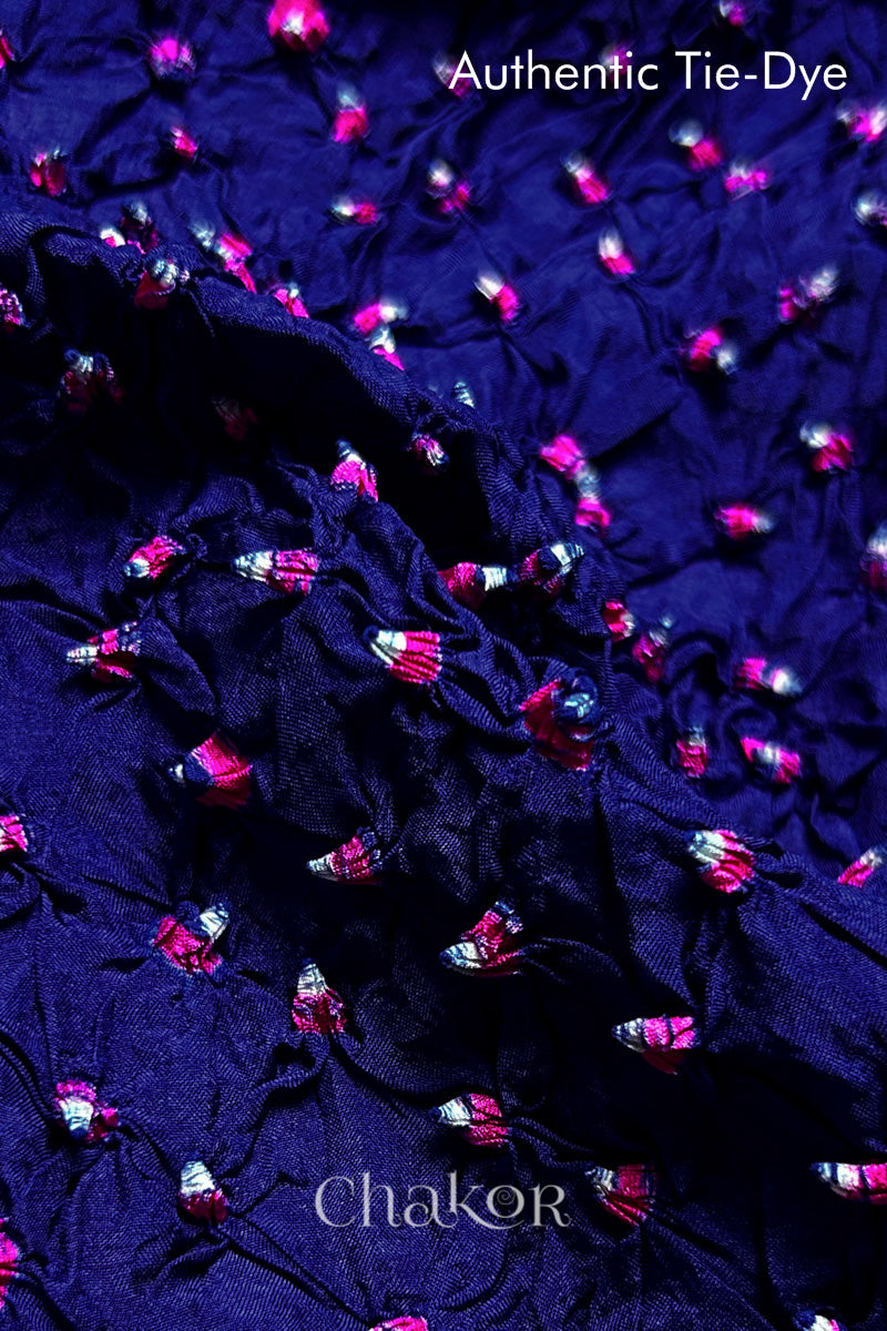 Close-up of Navy mulberry silk fabric with Pink and white patterns, featuring texture of authentic bandhani patterns.
