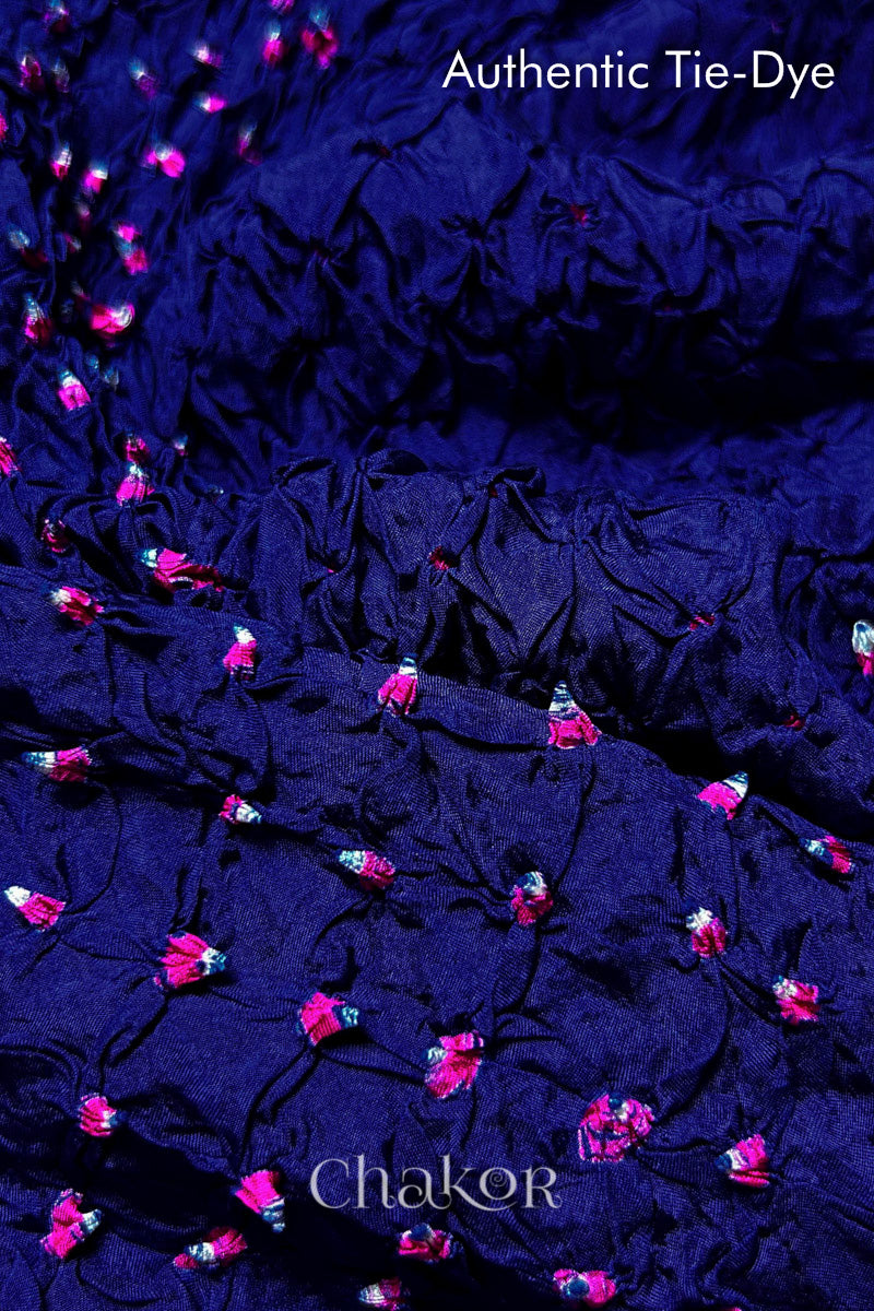 Close-up of Navy mulberry silk fabric with Pink and white patterns, featuring texture of authentic bandhani patterns.
