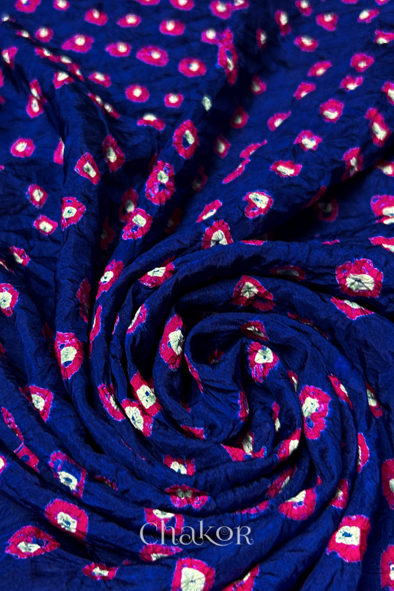 Navy Mulberry silk fabric with dual colour Pink bandhani dots, arranged in a swirling design  & Chakor brand watermark.
