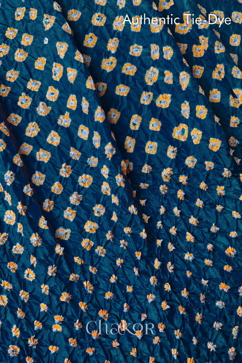 Close-up of Deep Indigo mulberry silk fabric with Yellow and white patterns, featuring texture of authentic bandhani patterns.

