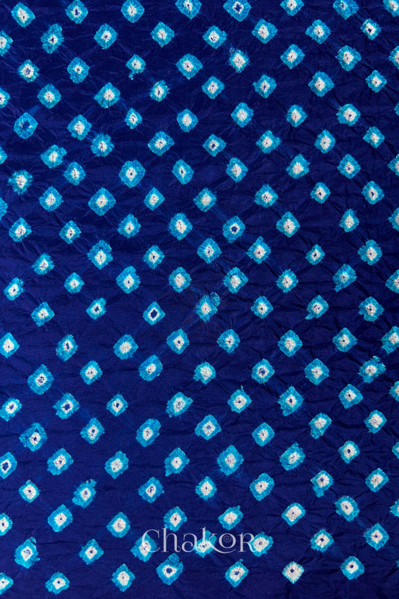 Navy Mulberry silk fabric showcasing dual colour Turquoise Blue bandhani patterns and Chakor brand watermark.
