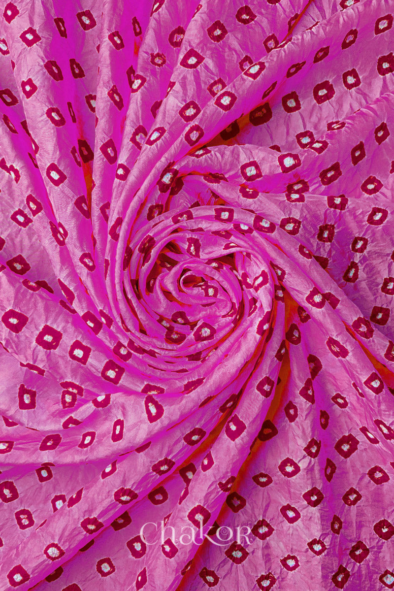 Light Pink Mulberry silk fabric with dual colour Pink bandhani dots, arranged in a swirling design  & Chakor brand watermark.
