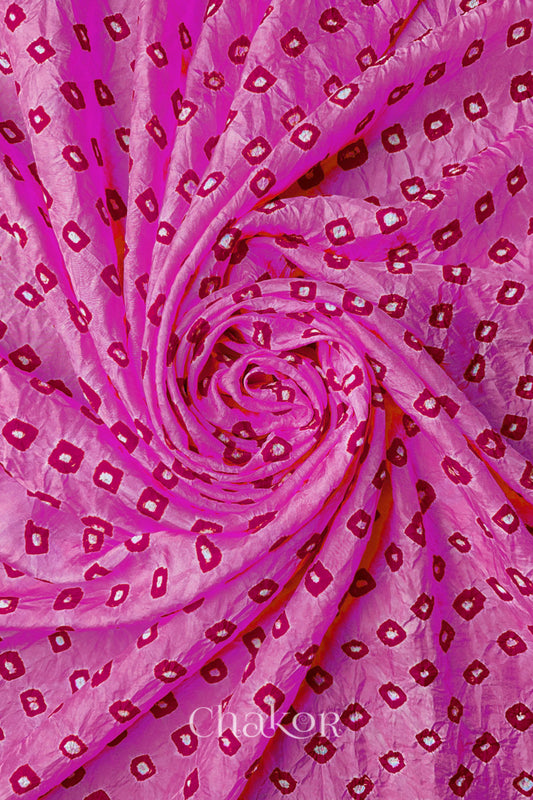 Light Pink Mulberry silk fabric with dual colour Pink bandhani dots, arranged in a swirling design  & Chakor brand watermark.
